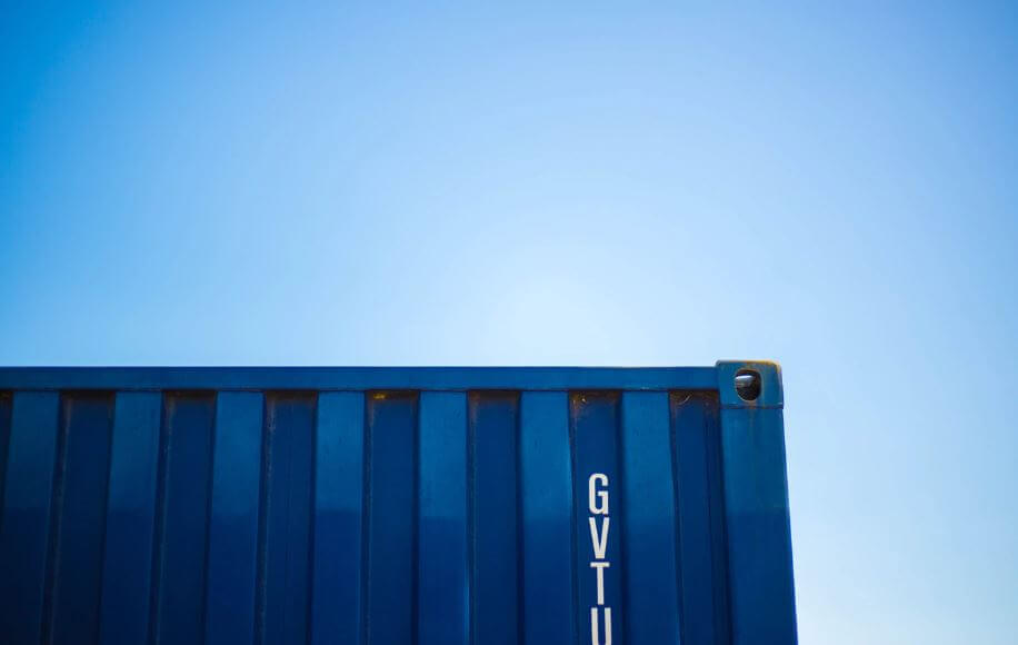 A close-up image of a blue-colored shipping container