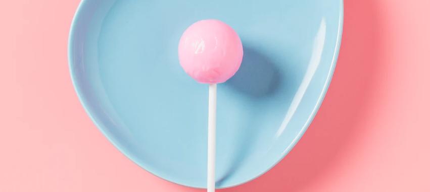 A sticky lollipop in a plate