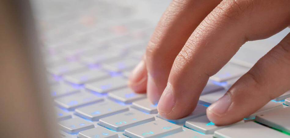 Fingers pressing keys on a keyboard